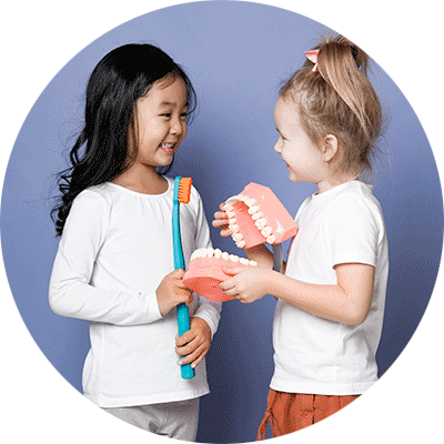 two girls playing with dentist stuff